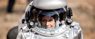 Female analog astronaut in space suit