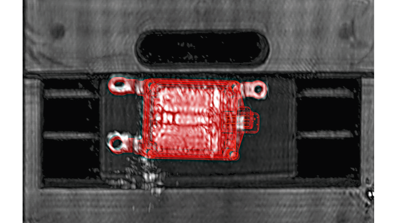 Millimeterwave image of the vehicle front with rear-mounted radar sensor and overlaid CAD data